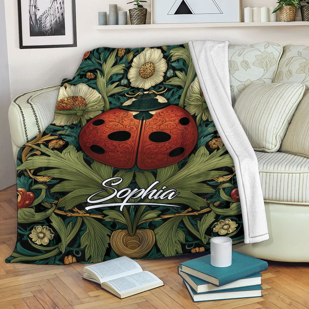 Ladybug blanket featuring a red beetle among flowers and leafy botanical artwork on a sofa