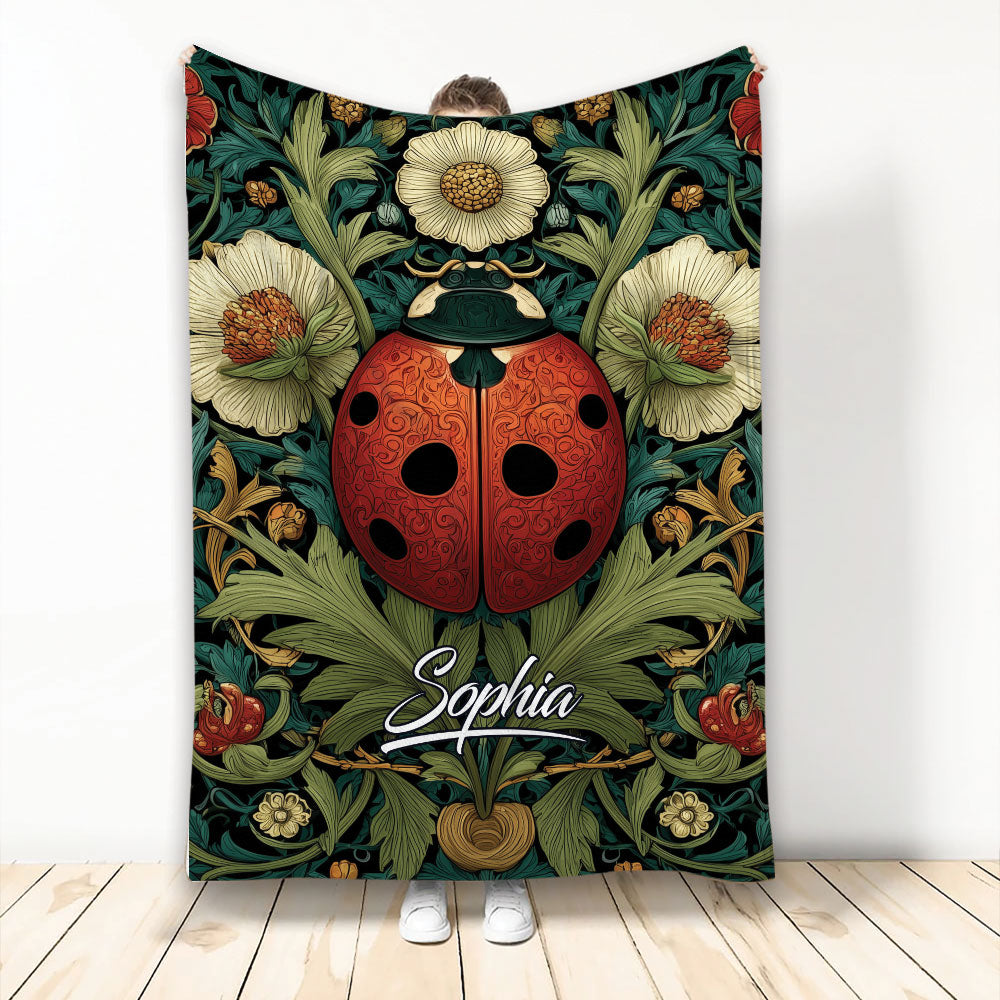 Ladybug throw blanket with ornate red beetle and botanical floral artwork displayed in a room