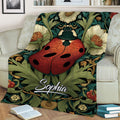 Botanical ladybug throw blanket draped over an armchair with detailed floral artwork