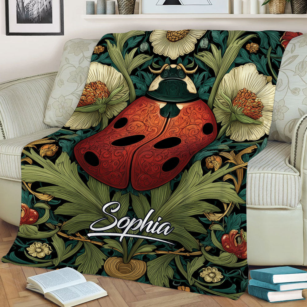Botanical ladybug throw blanket draped over an armchair with detailed floral artwork