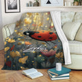 Ladybug blanket draped over a sofa, featuring floral artwork and a warm golden botanical background