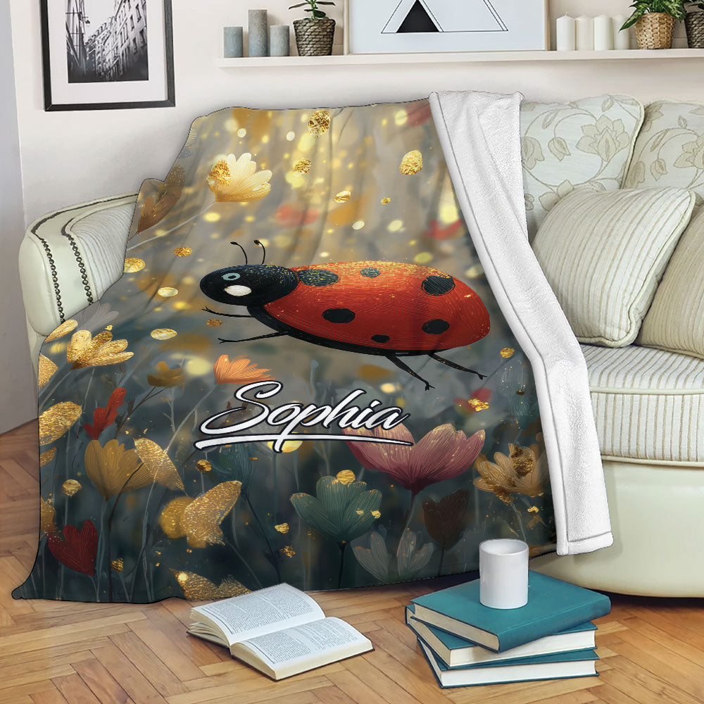 Ladybug blanket draped over a sofa, featuring floral artwork and a warm golden botanical background