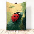 Ladybug throw blanket with a colorful red insect resting on layered green leaves