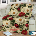 Floral ladybug blanket displayed on a sofa with colorful flowers, greenery, and garden artwork