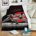 Karate blanket draped over a sofa, featuring martial artists in white uniforms and dramatic red artwork