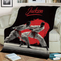Black karate throw blanket displayed on a couch with dynamic martial arts training artwork