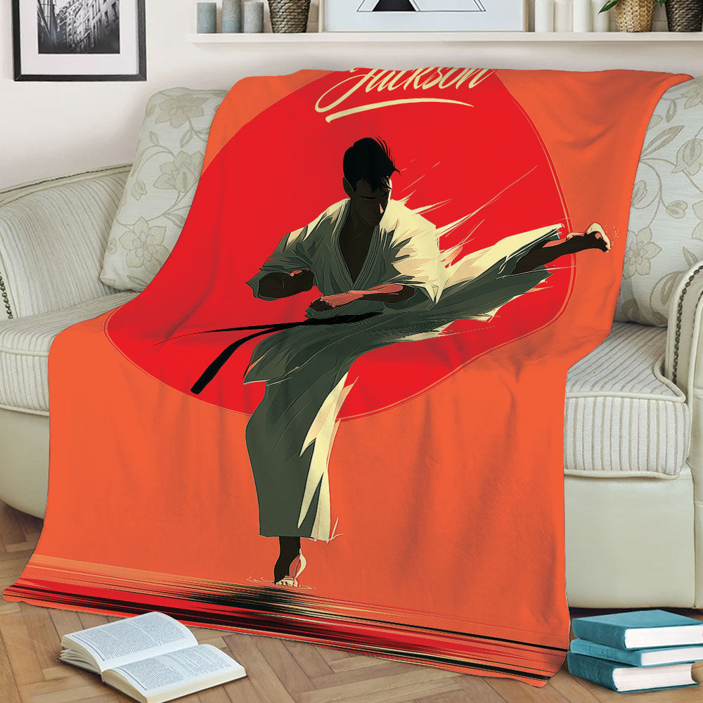 Karate blanket displayed on a couch with a dramatic kicking martial artist design