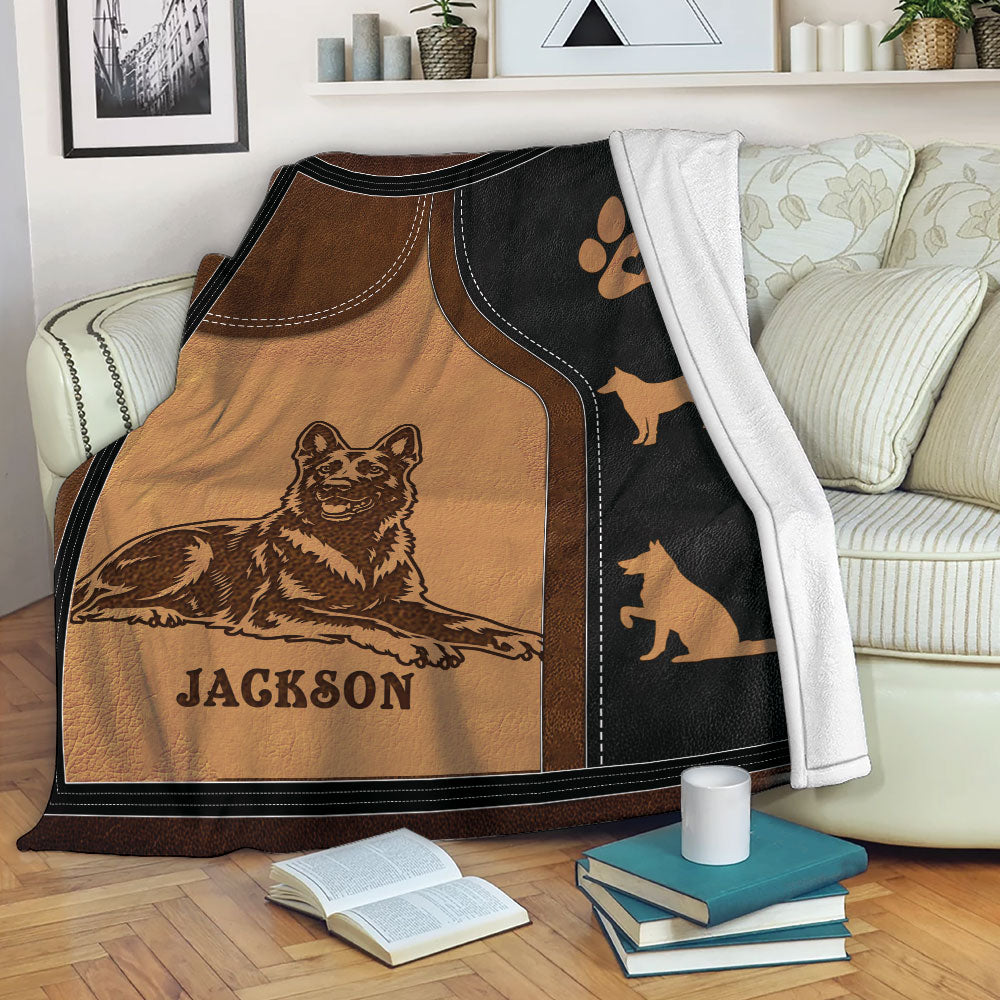 Dutch Shepherd blanket displayed on a living room sofa with detailed dog artwork and warm brown and black tones