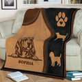 Close view of a Bloodhound blanket draped over a sofa with paw print and dog silhouette details