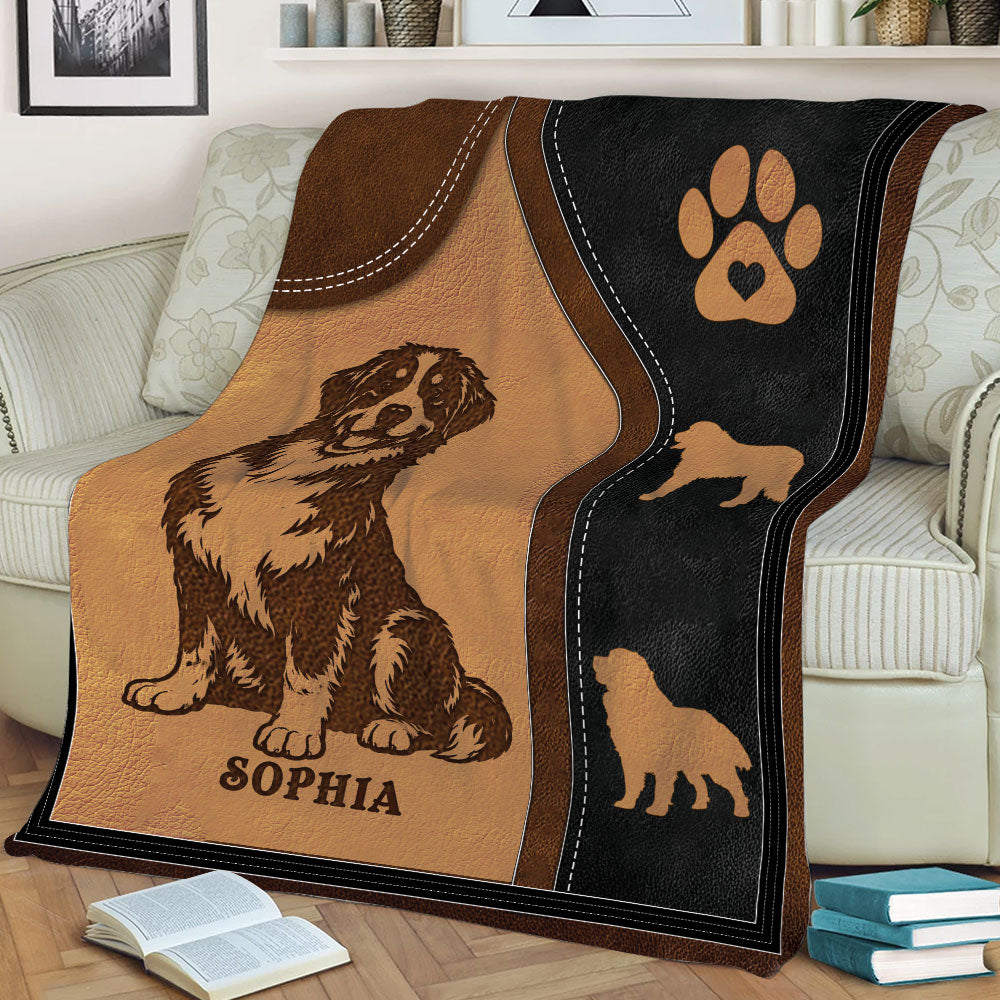 Close view of a Bernese Mountain Dog throw blanket displayed on a sofa with rustic dog artwork