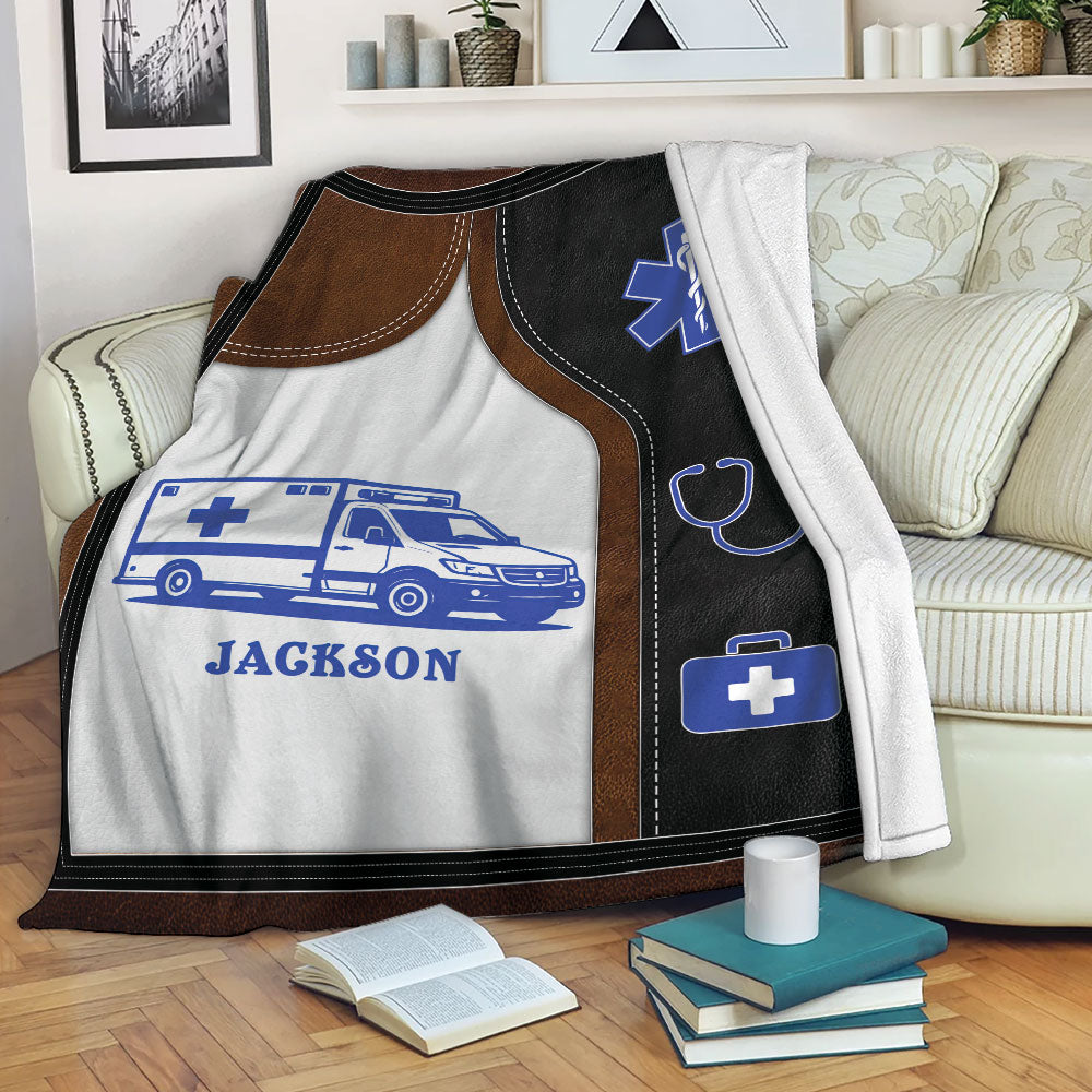 Paramedic throw blanket displayed on a sofa with ambulance and blue EMS medical artwork