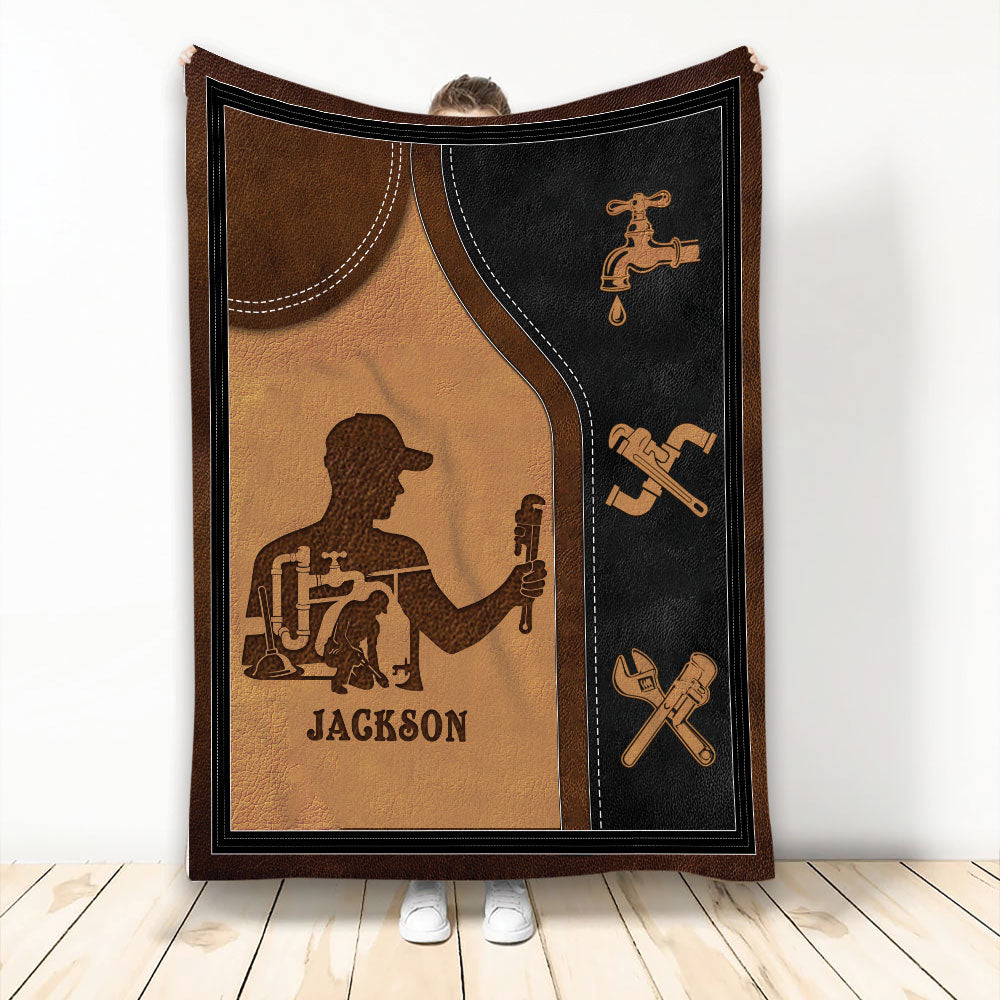 Plumber throw blanket featuring a working plumber silhouette, faucet icon, crossed tools, and warm brown artwork