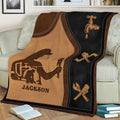 Close view of a plumber throw blanket with a working plumber silhouette, faucet graphic, and crossed wrench design