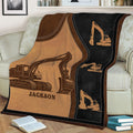 Close view of an excavator blanket showing detailed digging machine artwork on a couch