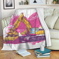 Excavator throw blanket displayed across a sofa with colorful construction vehicle artwork