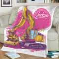 Excavator blanket draped over a chair featuring bold yellow machinery and vibrant pink artwork