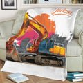 Close view of an excavator blanket draped over a sofa with bold industrial artwork