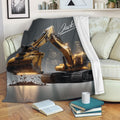 Excavator throw blanket draped over a sofa with detailed yellow heavy equipment artwork
