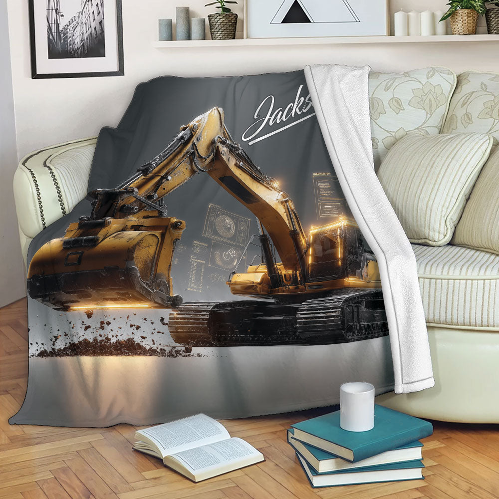 Excavator throw blanket draped over a sofa with detailed yellow heavy equipment artwork