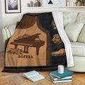 Piano blanket draped over a sofa, featuring grand piano artwork, musical notes, and warm vintage colors