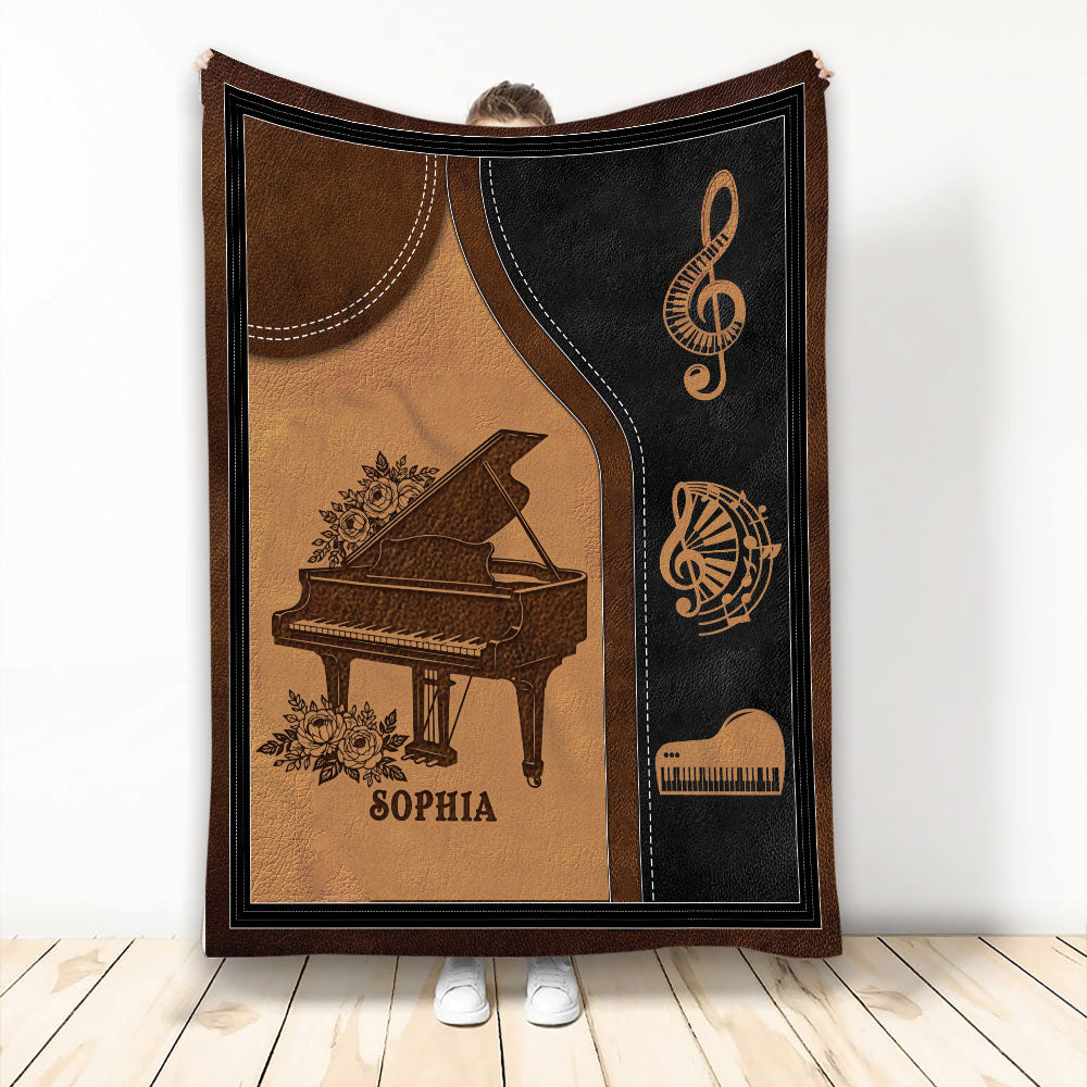 Piano throw blanket with grand piano, musical notes, floral accents, and warm brown and black artwork