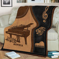 Close lifestyle view of a piano throw blanket with grand piano and musical note artwork on a sofa