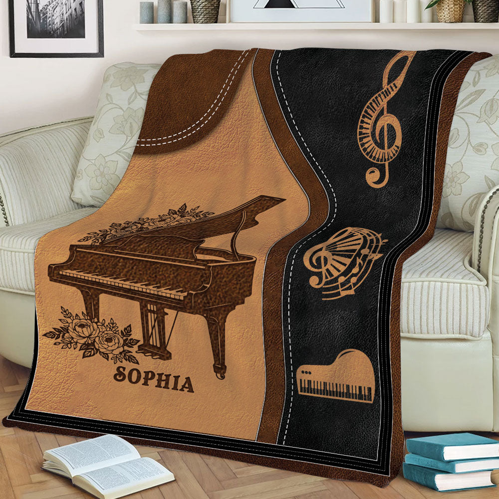 Close lifestyle view of a piano throw blanket with grand piano and musical note artwork on a sofa