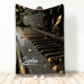 Piano throw blanket with glowing black and gold keys, floating musical notes, and elegant music artwork