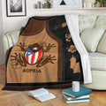 Puerto Rico blanket displayed on a sofa with coqui frog artwork, island symbols, and tropical floral details