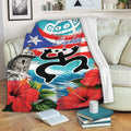 Puerto Rico throw blanket draped over a sofa with colorful flag, tropical flower, and island artwork
