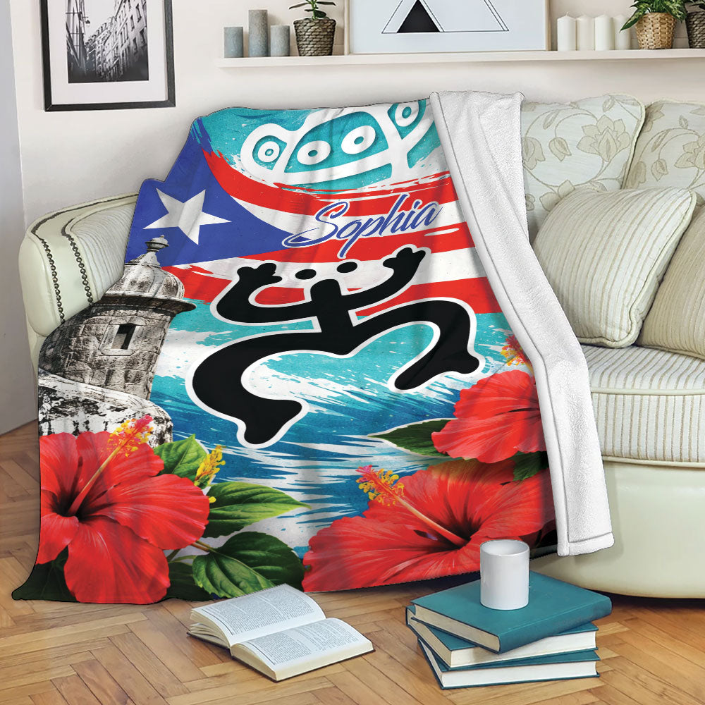 Puerto Rico throw blanket draped over a sofa with colorful flag, tropical flower, and island artwork