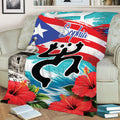 Close lifestyle view of a Puerto Rico blanket featuring bold flag colors, coqui artwork, fort, and hibiscus