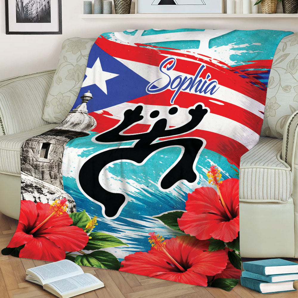Close lifestyle view of a Puerto Rico blanket featuring bold flag colors, coqui artwork, fort, and hibiscus