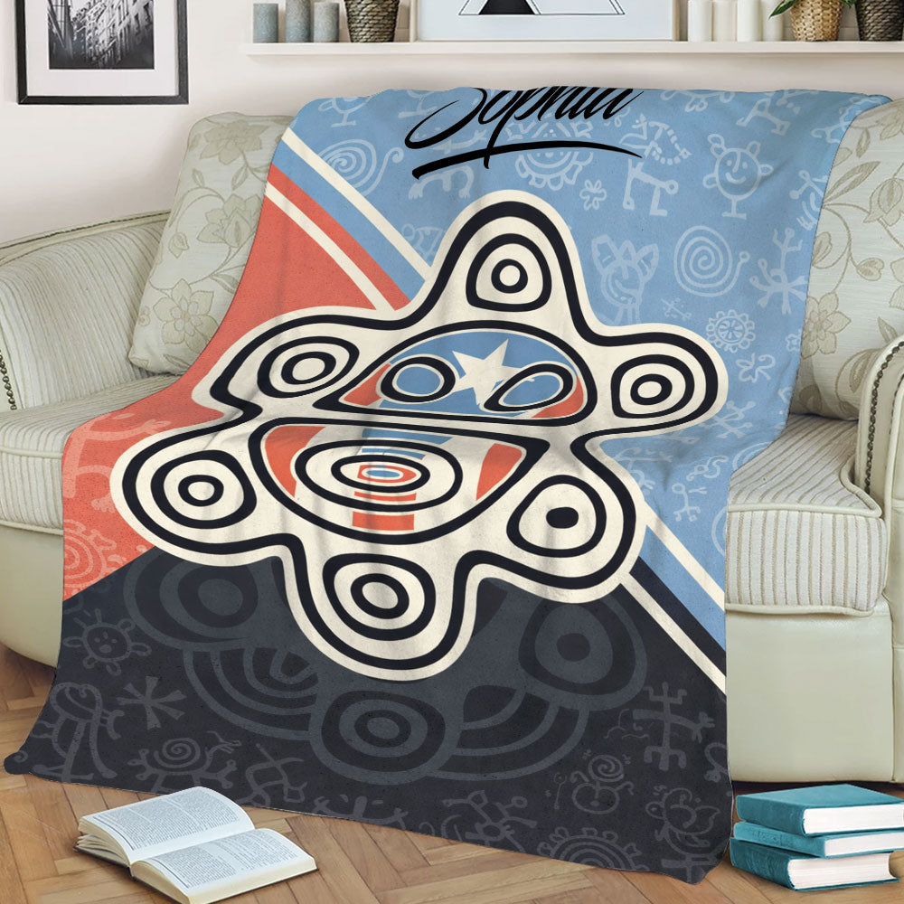 Close view of a Puerto Rico themed blanket featuring a large stylized sun motif and colorful graphic details