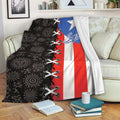 Puerto Rico flag blanket with black heritage-inspired artwork draped over a living room sofa
