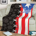 Close lifestyle view of a Puerto Rican flag throw blanket with bold red, white, blue and black artwork