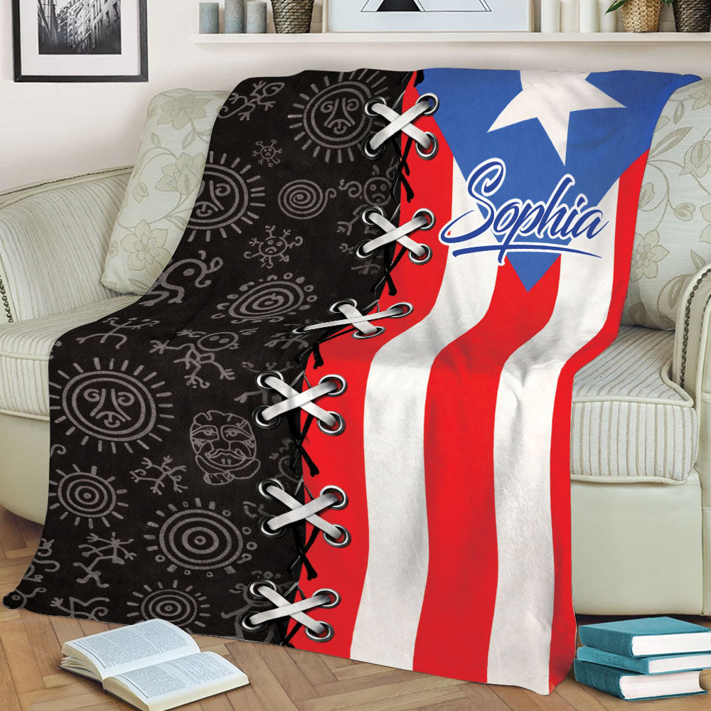Close lifestyle view of a Puerto Rican flag throw blanket with bold red, white, blue and black artwork