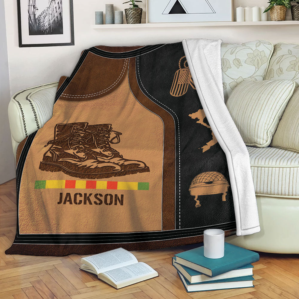 Vietnam Veteran blanket displayed on a couch with military boots, helmet, Vietnam map, and tribute artwork
