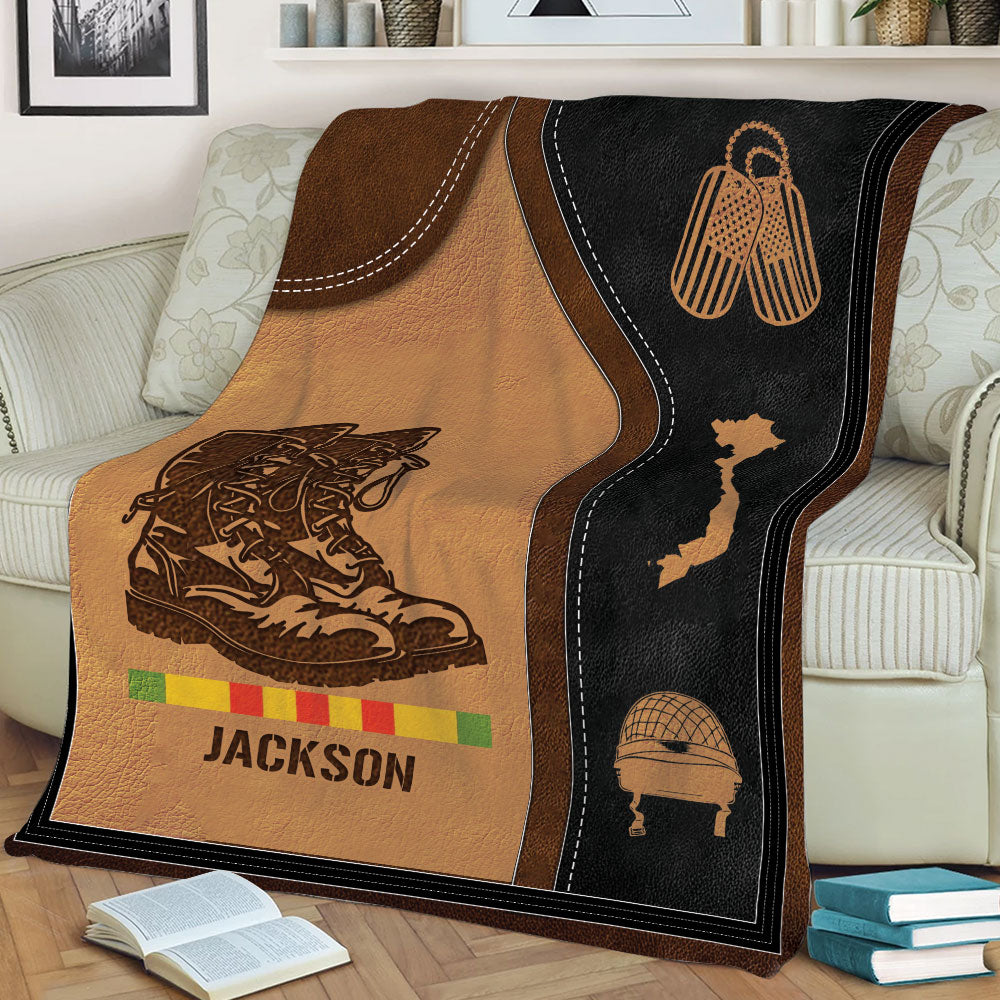 Close view of Vietnam Veteran throw blanket featuring combat boots, helmet, Vietnam map, and vintage military styling