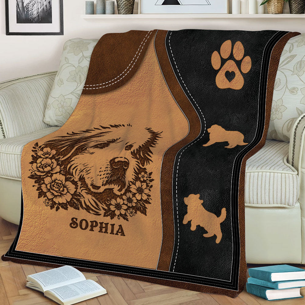 Close view of a Great Pyrenees throw blanket with floral dog artwork, paw print, and warm rustic colors