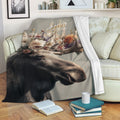 Floral moose throw blanket draped over a sofa in a cozy living room