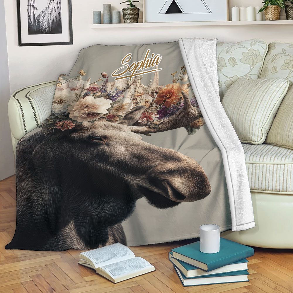 Floral moose throw blanket draped over a sofa in a cozy living room