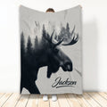 Moose throw blanket featuring a detailed black and gray moose in a misty evergreen forest