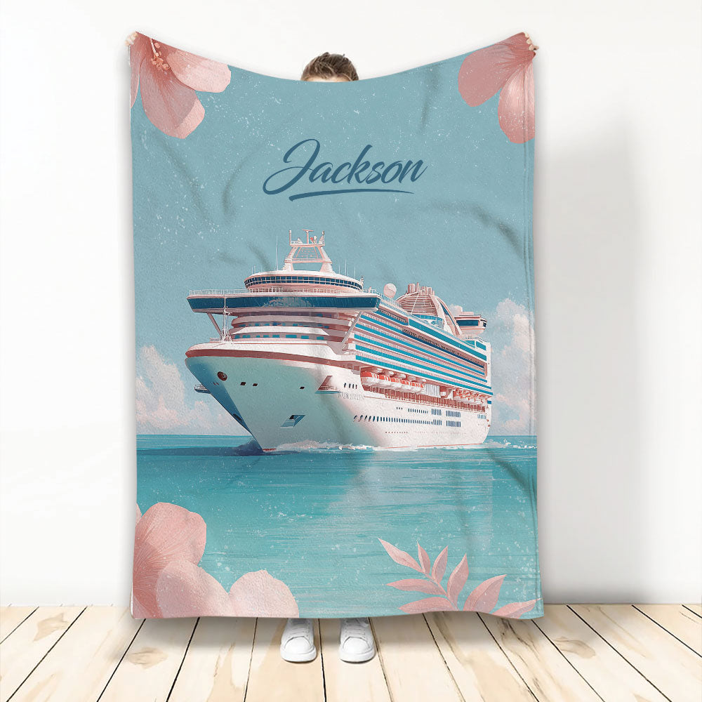 Cruise ship blanket with ocean artwork, turquoise water, and pink floral accents