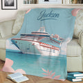 Cruise ship blanket draped over a sofa with turquoise sea artwork and pink botanical details