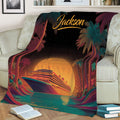 Tropical cruise ship throw blanket displayed on a sofa with colorful sunset ocean artwork