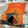 Close lifestyle view of a cruise ship throw blanket on a couch with sunset nautical artwork