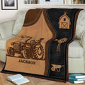 Close view of a custom farm throw blanket featuring a tractor, barn, windmill, and wheelbarrow