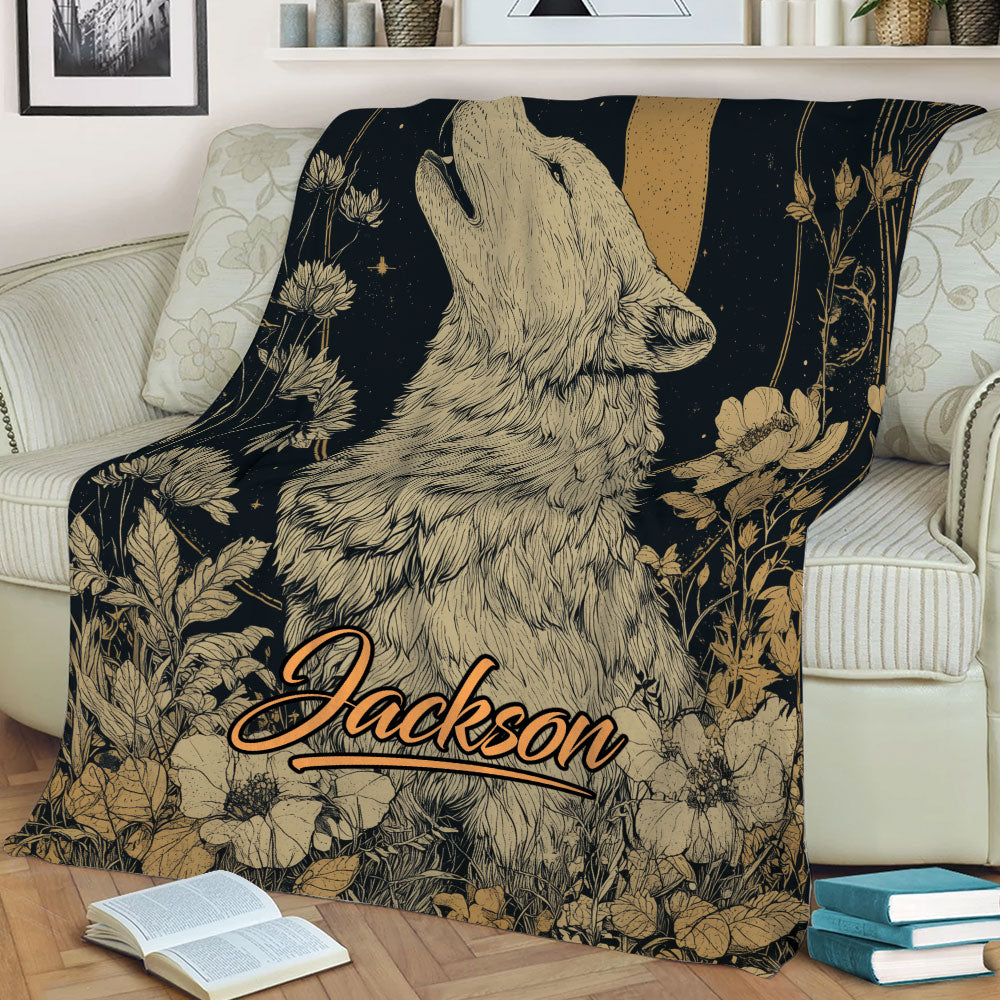 Wolf throw blanket draped over a sofa with botanical details and a warm crescent moon