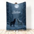 Moonlit wolf throw blanket displayed upright with two howling wolves in a snowy forest